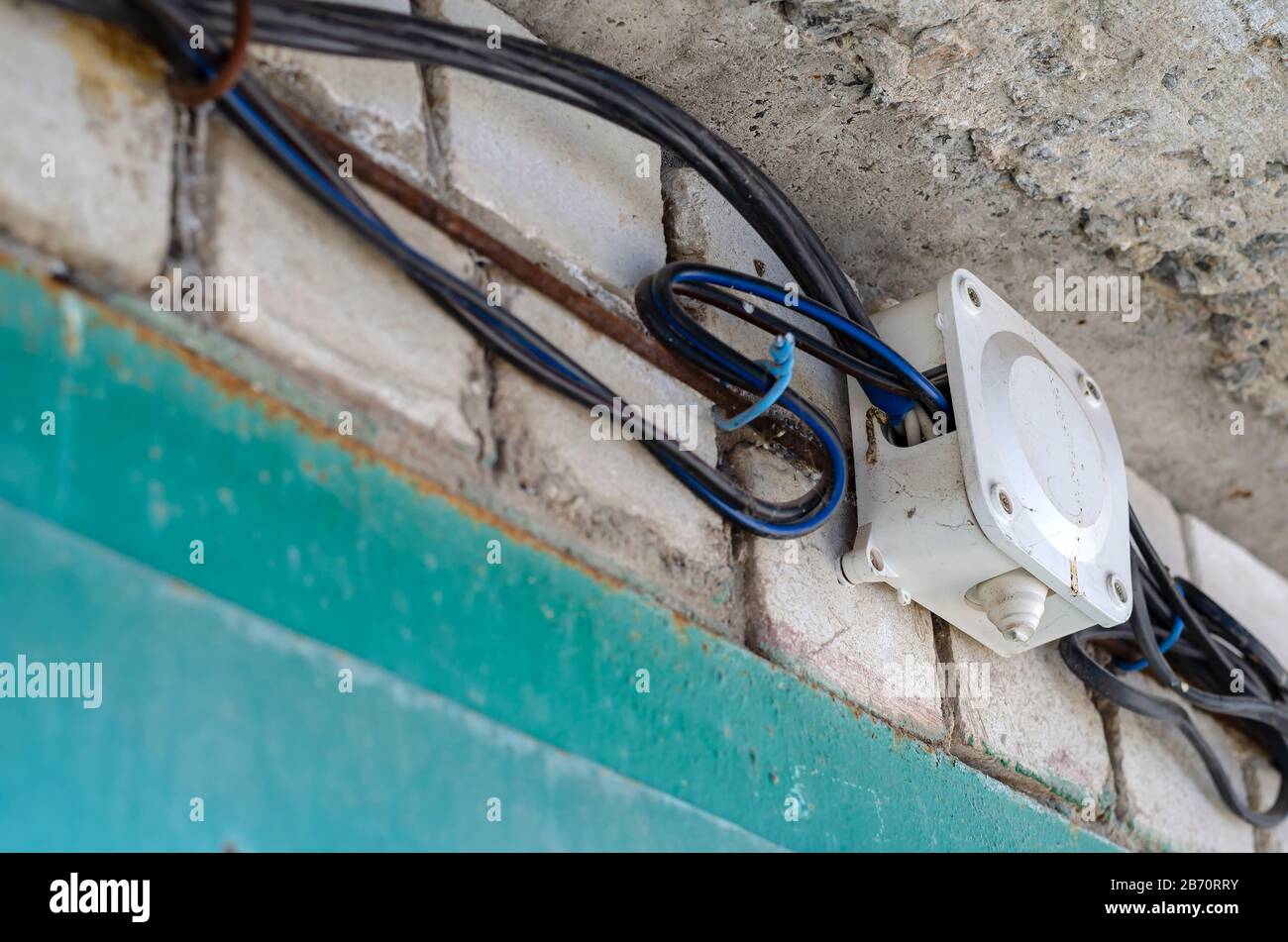 Junction box for wiring with electrical cables on the wall. Wires in
