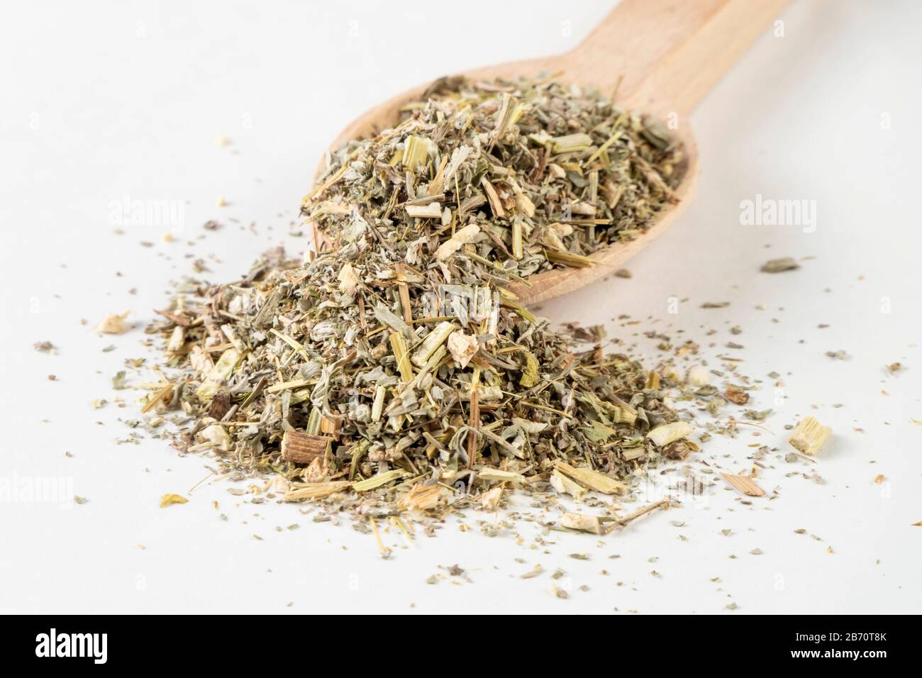 wormwood herb or in latin Absinthii herba herb in wooden spoon isolated on white background. medicinal healing herbs. herbal medicine. alternative med Stock Photo