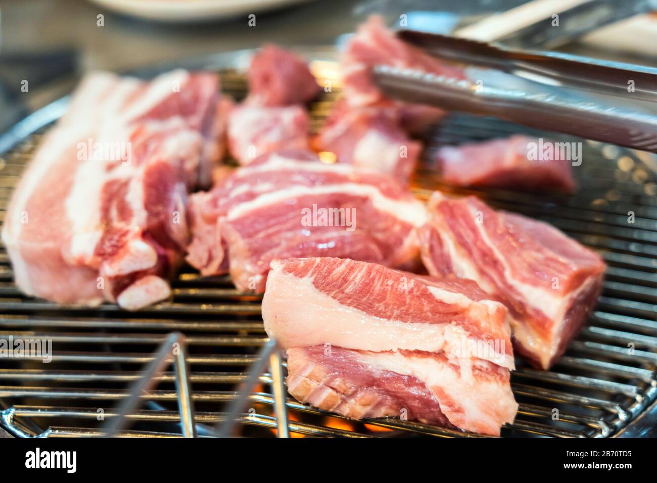 Preparing Traditional Korean Barbecue Grill Pork. Closeup View of Grilling Fresh Raw Meat Stock