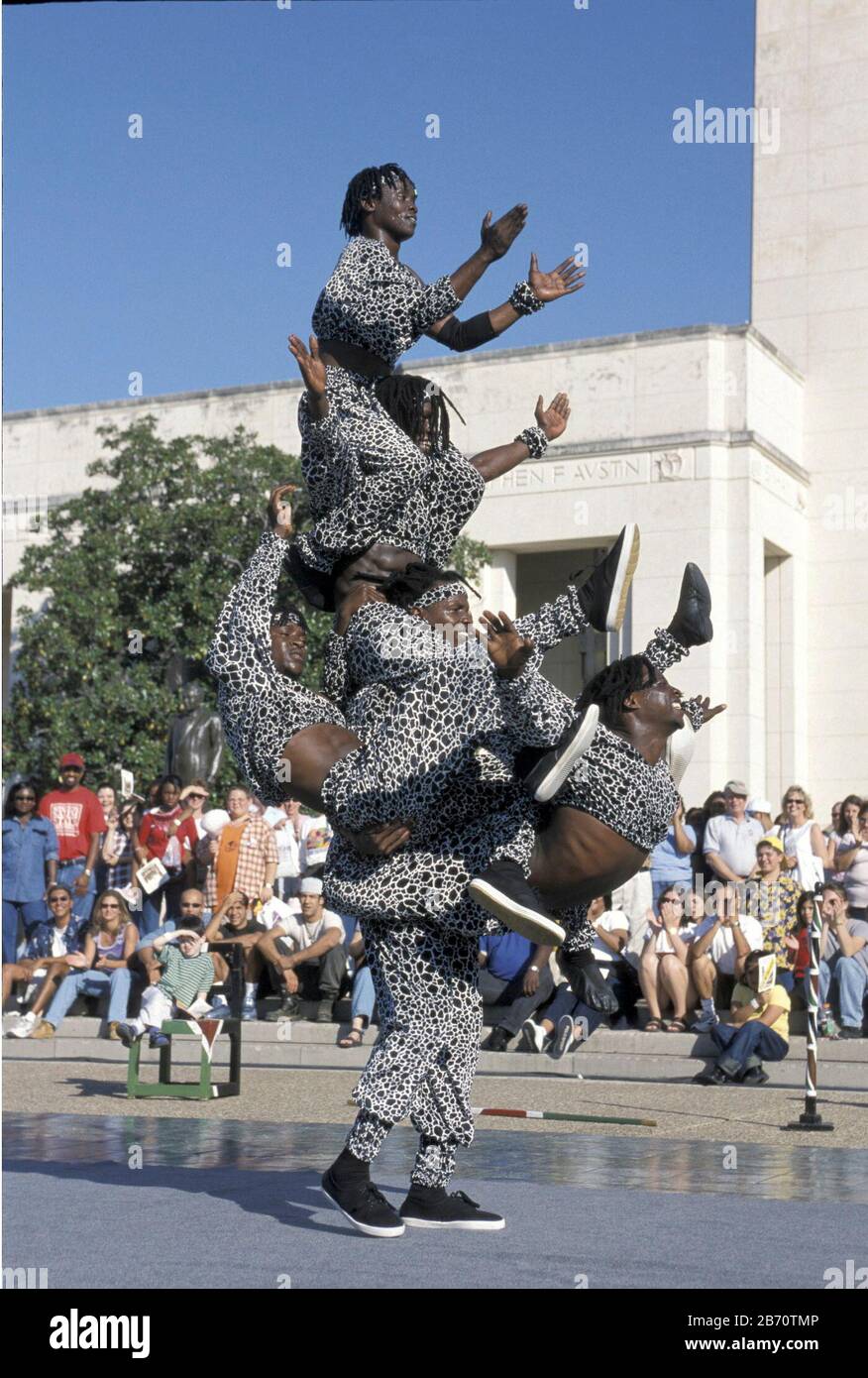 Dallas, Texas USA, October 2001: Black acrobats from Kenya performing for visitors at the State Fair of Texas.  ©Bob Daemmrich Stock Photo