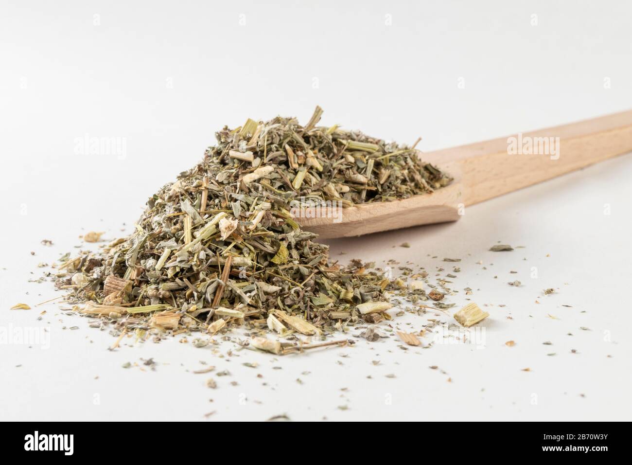 wormwood herb or in latin Absinthii herba herb in wooden spoon isolated