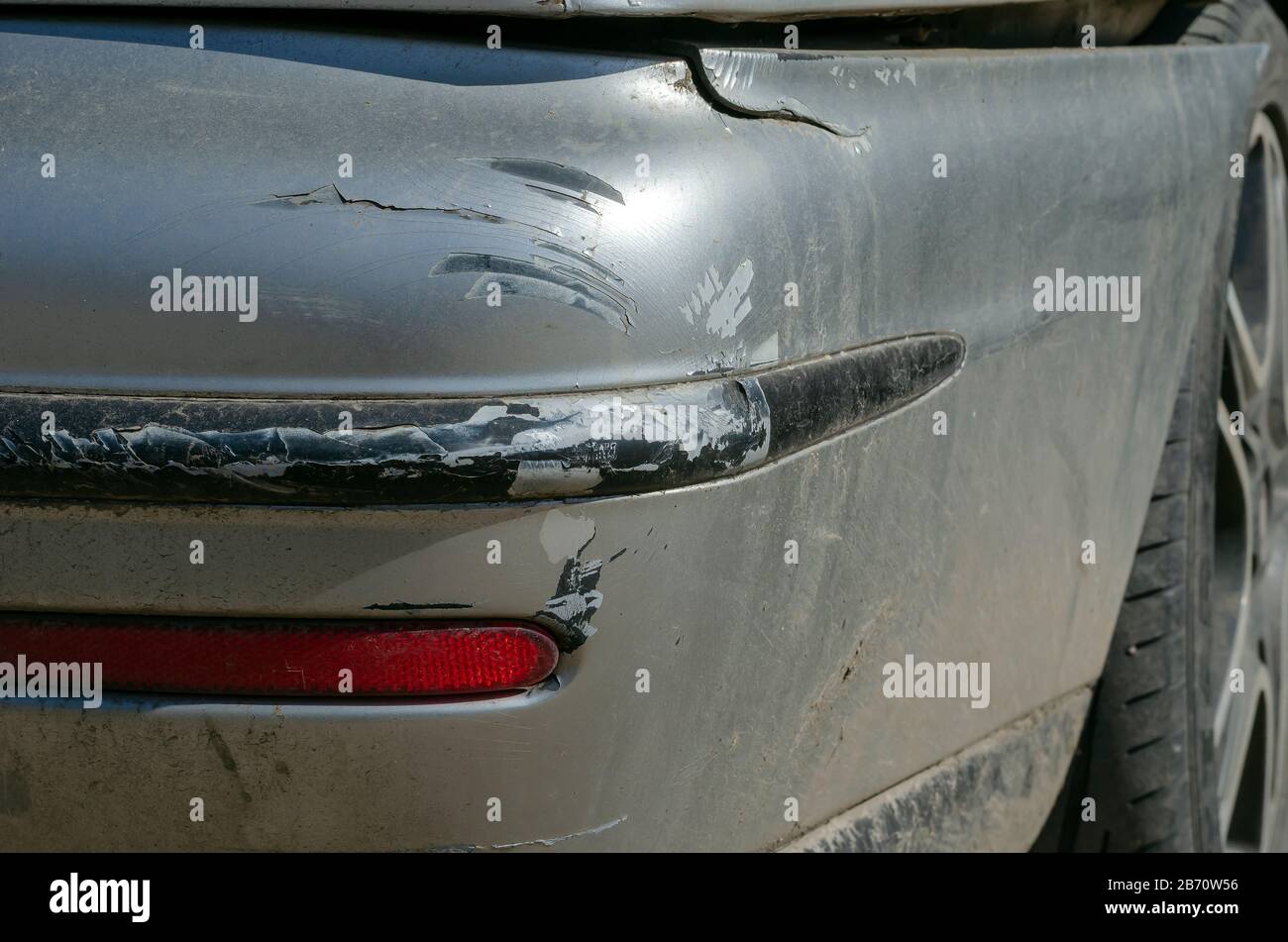 Damaged rear bumper closeup. Cracked gray bumper. Car accident