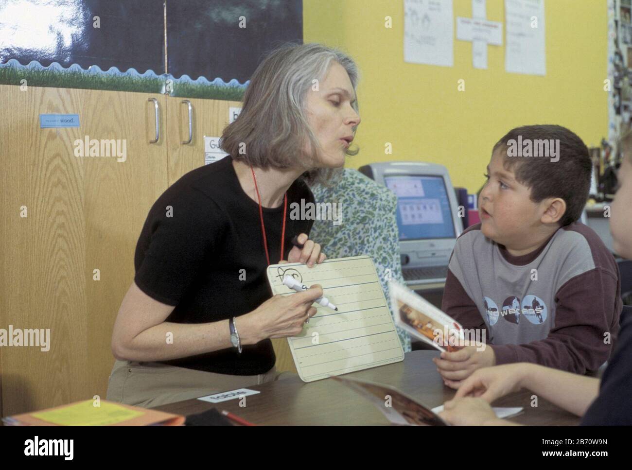 Austin, Texas USA, 2003: First grade teacher points to vocabulary words in classroom at Metz Elementary School. MR ©Bob Daemmrich Stock Photo