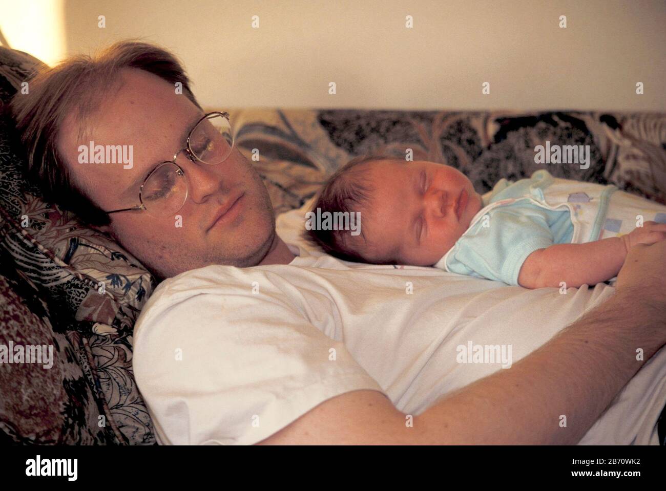 Austin Texas USA Three Week Old Baby Sleeping With Dad On Couch MR Austin texas usa three week old baby sleeping with dad on couch mr