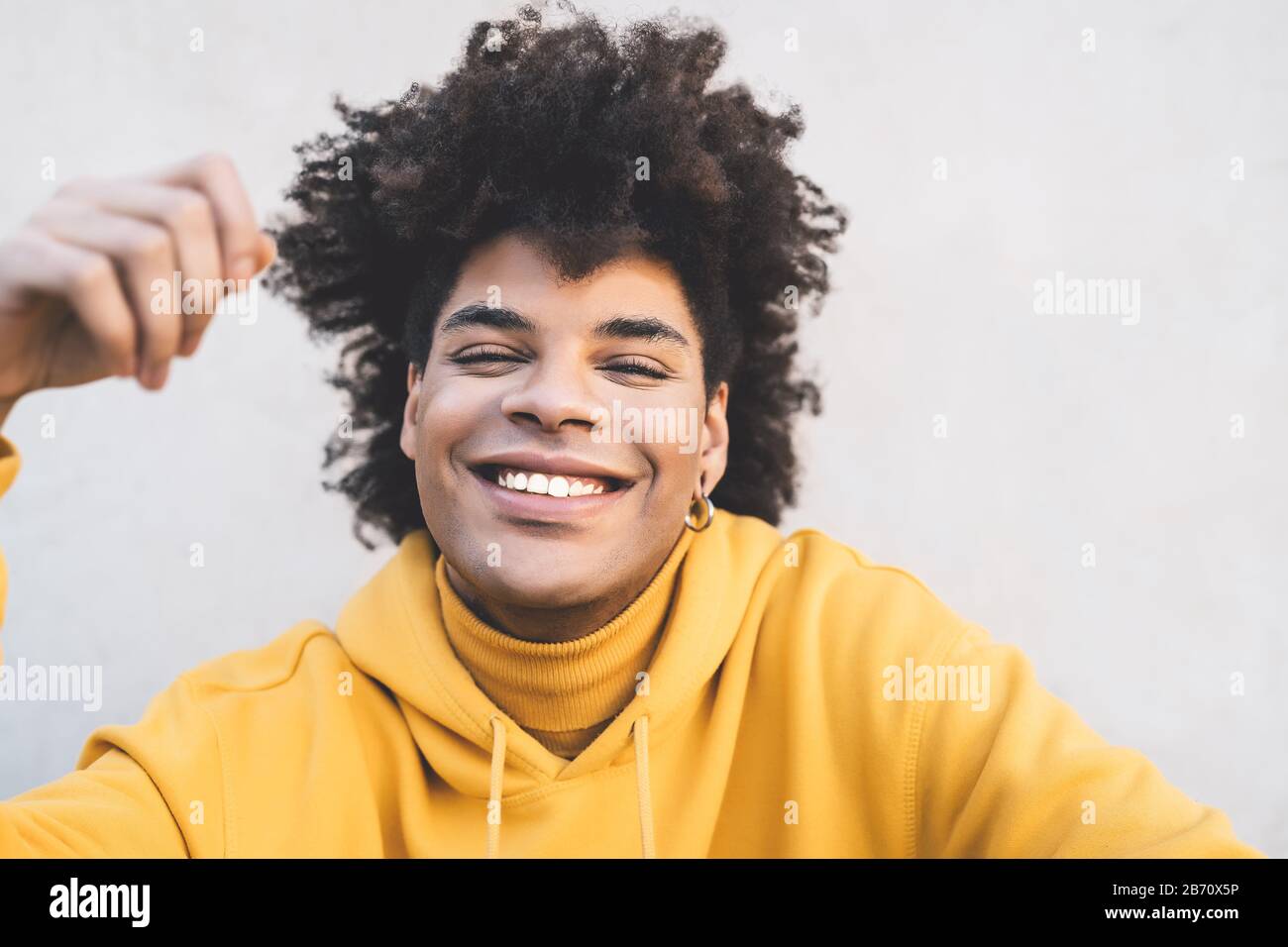 Afro smiling man portrait - Mixed race young guy having fun posing in front camera Stock Photo