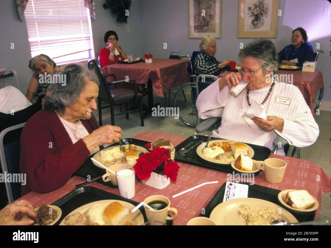 Austin Texas USA: Female residents of nursing home eating meal in facility's dining room. NMR   ©Bob Daemmrich Stock Photo