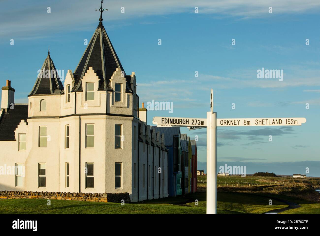 The famous John O'Groats Hotel, with the end of Britain sign, now The Inn at John O'Groats, John O'Groats, Caithness, Scotland, UK Stock Photo