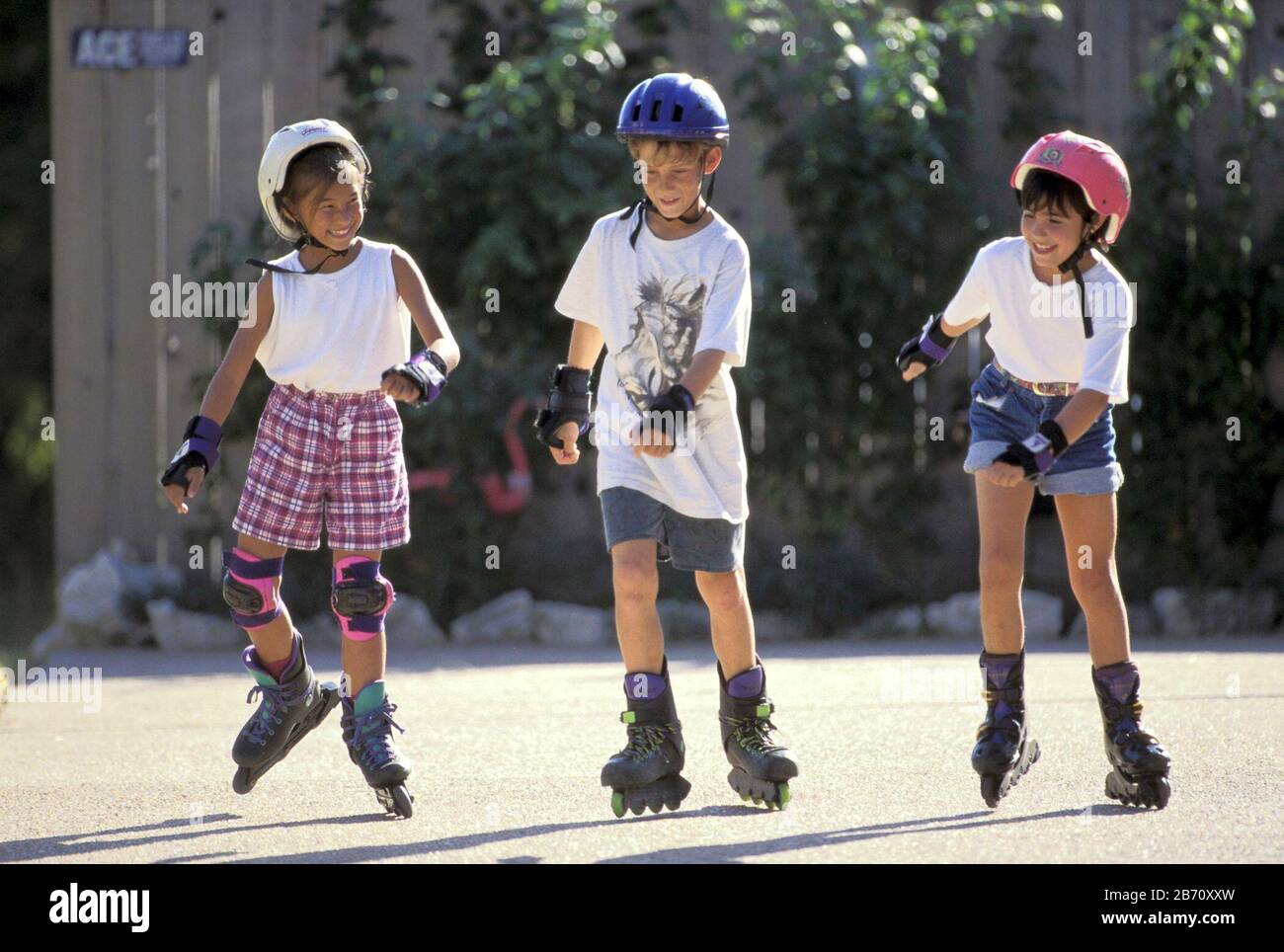 Austin, Texas USA Children wearing helmets and kneepads rollerblade