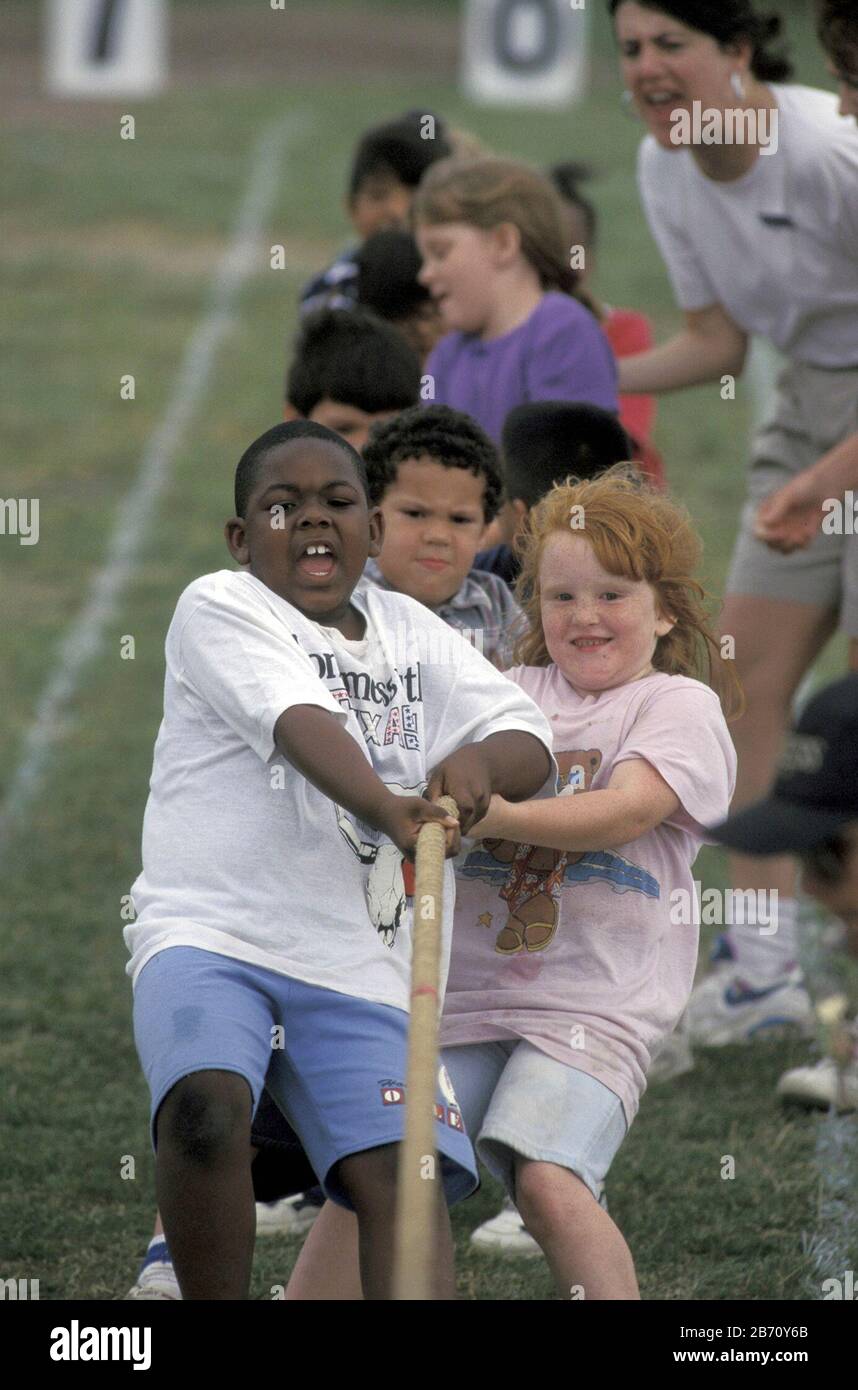 Austin Texas USA: Third-grade students compete in tug of war game during elementary school field day. Stock Photo