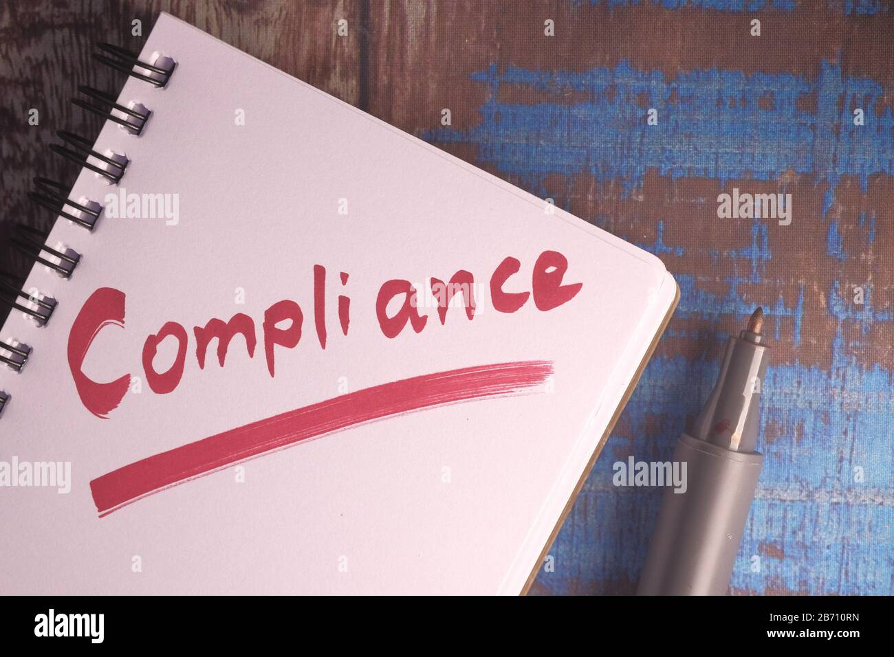 compliance word written on notepad on table  Stock Photo
