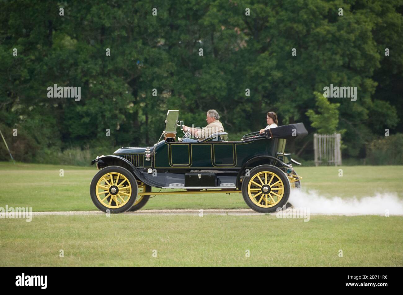 vintage classic car driving through park Stock Photo Alamy
