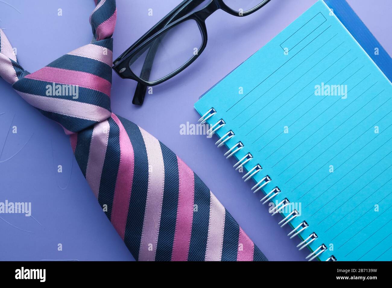 Fathers day concept with tie, notepad and eyeglass on table. Stock Photo
