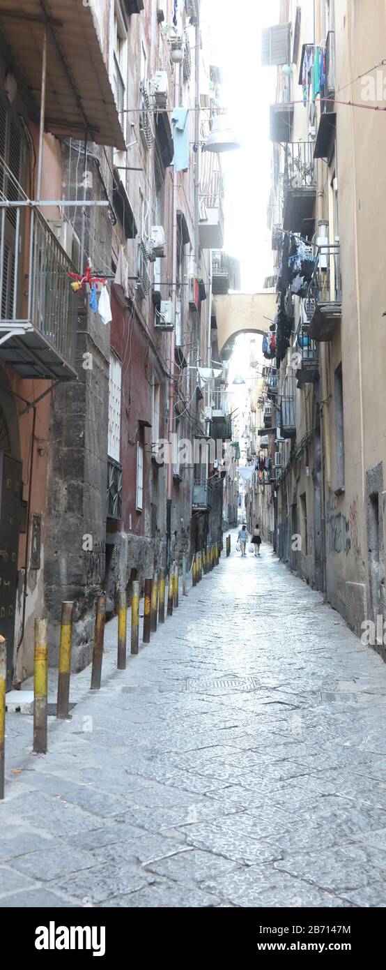 narrow alley in the middle of the popular houses in the district of Naples in Italy Stock Photo