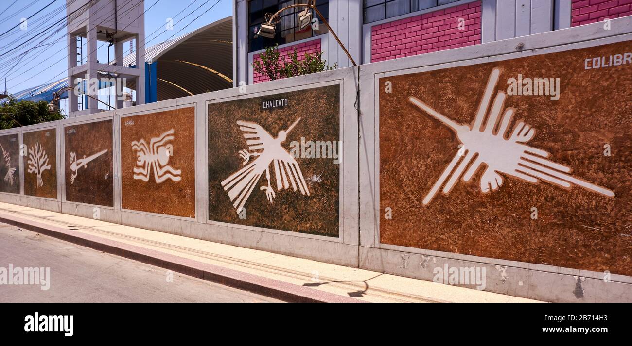 Nazca lines wall illustrations on town street Stock Photo