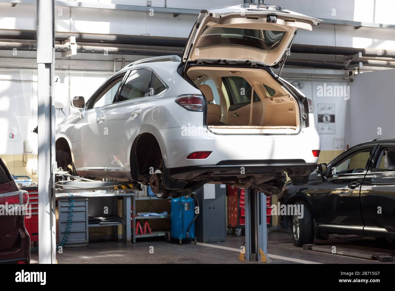 Russia, Izhevsk - April 21, 2018: Automobile workshop. Replacement and wheel alignment on a hydraulic lift. Modern service. Stock Photo