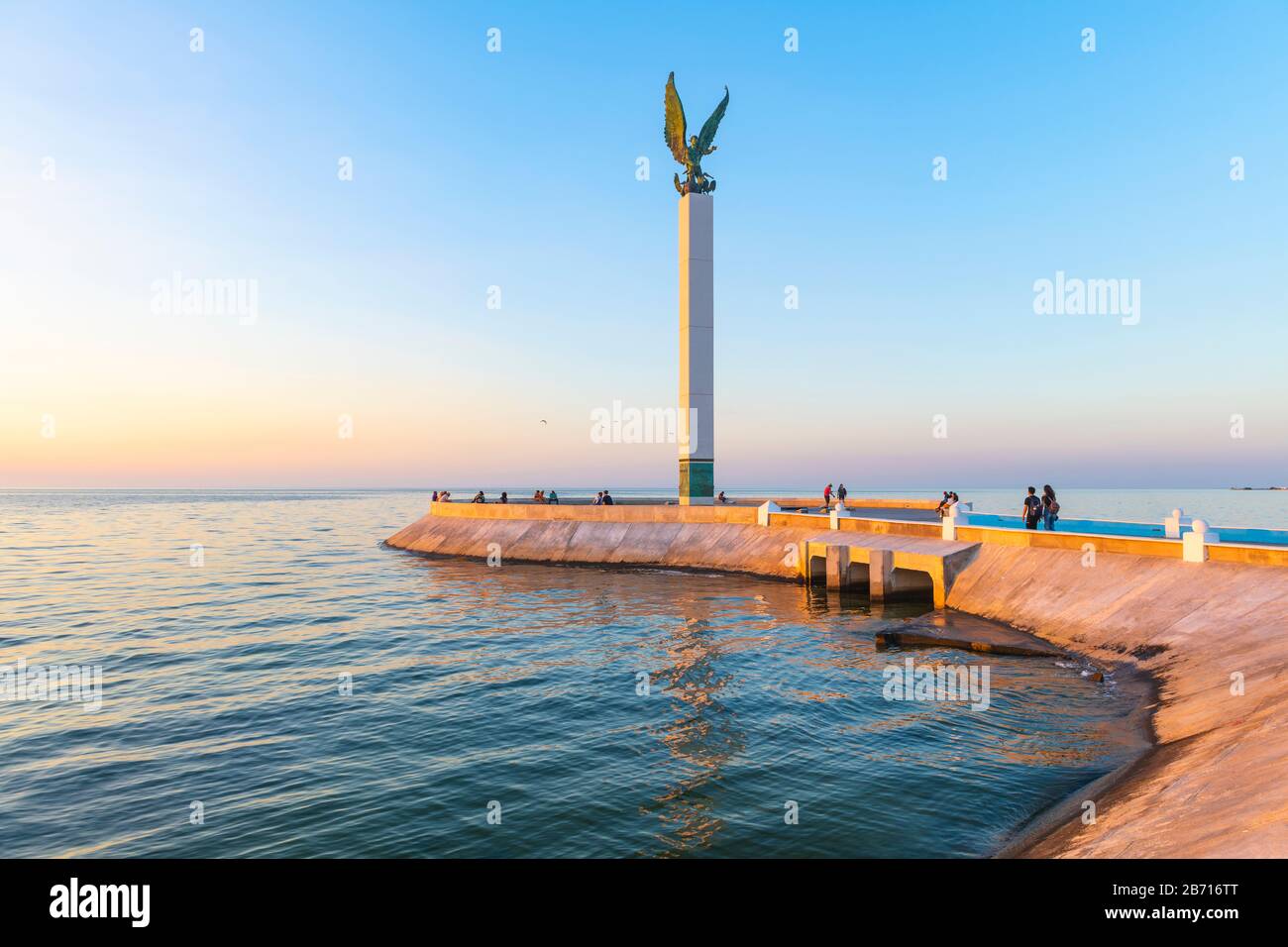 The pier of Campeche illuminated at sunset and its waterfront promenade with people by the Gulf of Mexico, Mexico. Stock Photo