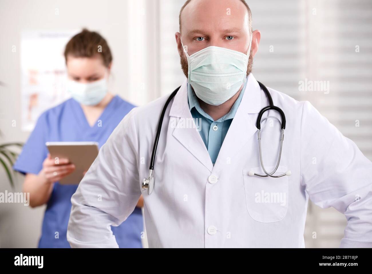 Confident Doctor And Nurse With Arms Crossed In Clinic Stock Photo - Alamy