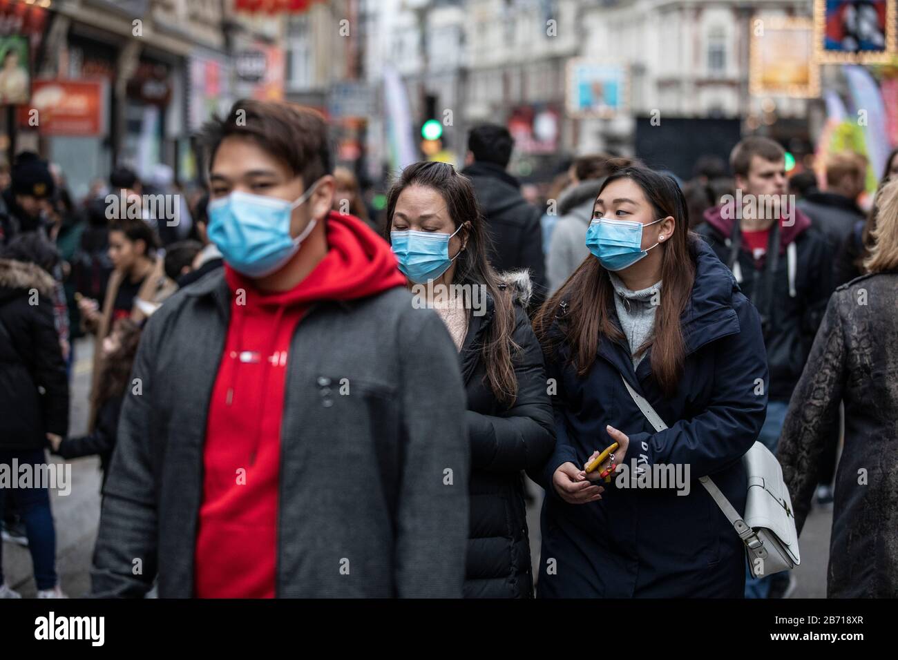 People wearing masks as precaution of catching Coronavirus at the Chinese New Year Celebration in London, Year of the Rat, Sunday 26th January 2020 UK Stock Photo