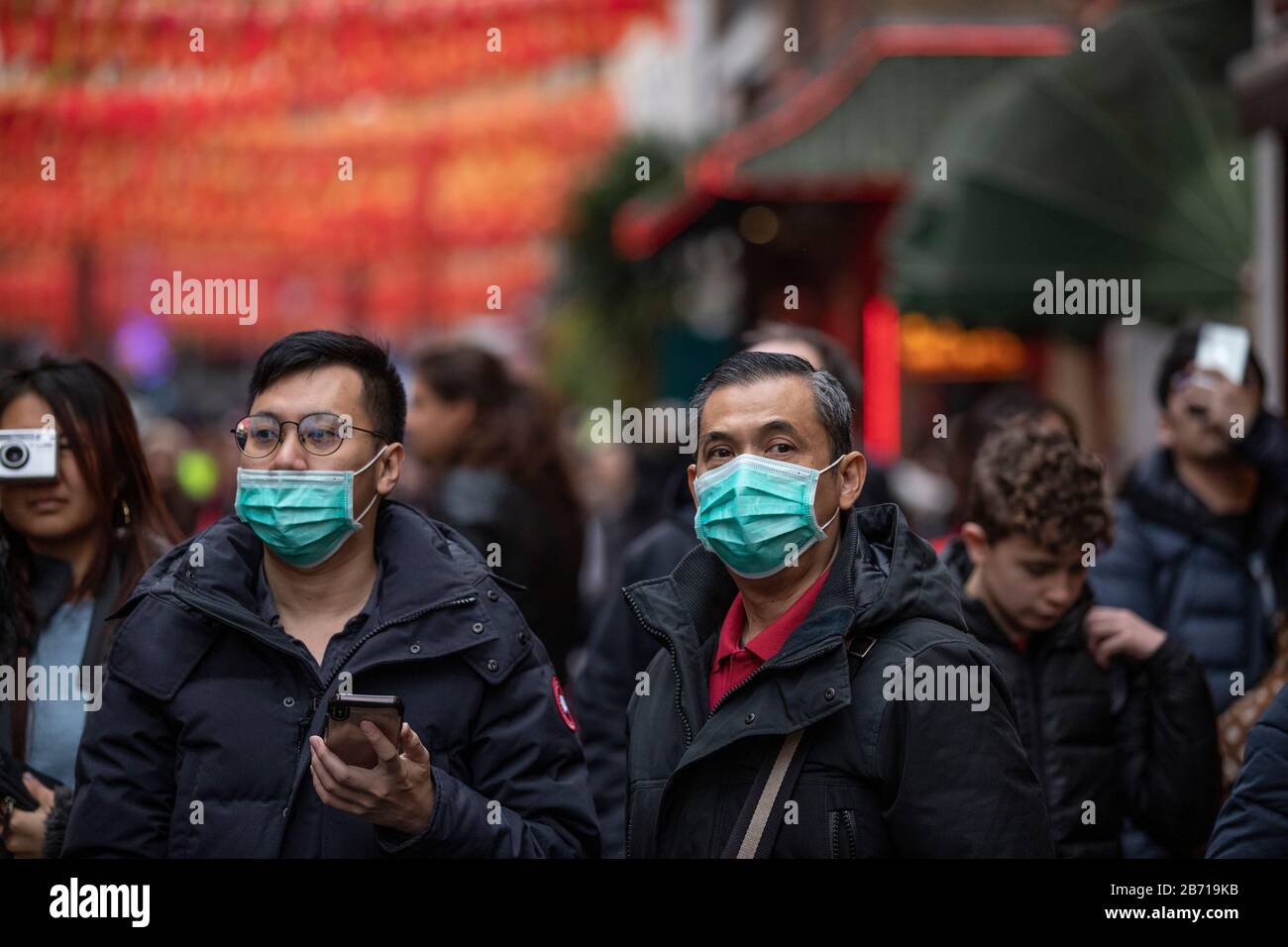 People wearing masks as precaution of catching Coronavirus at the Chinese New Year Celebration in London, Year of the Rat, Sunday 26th January 2020 UK Stock Photo