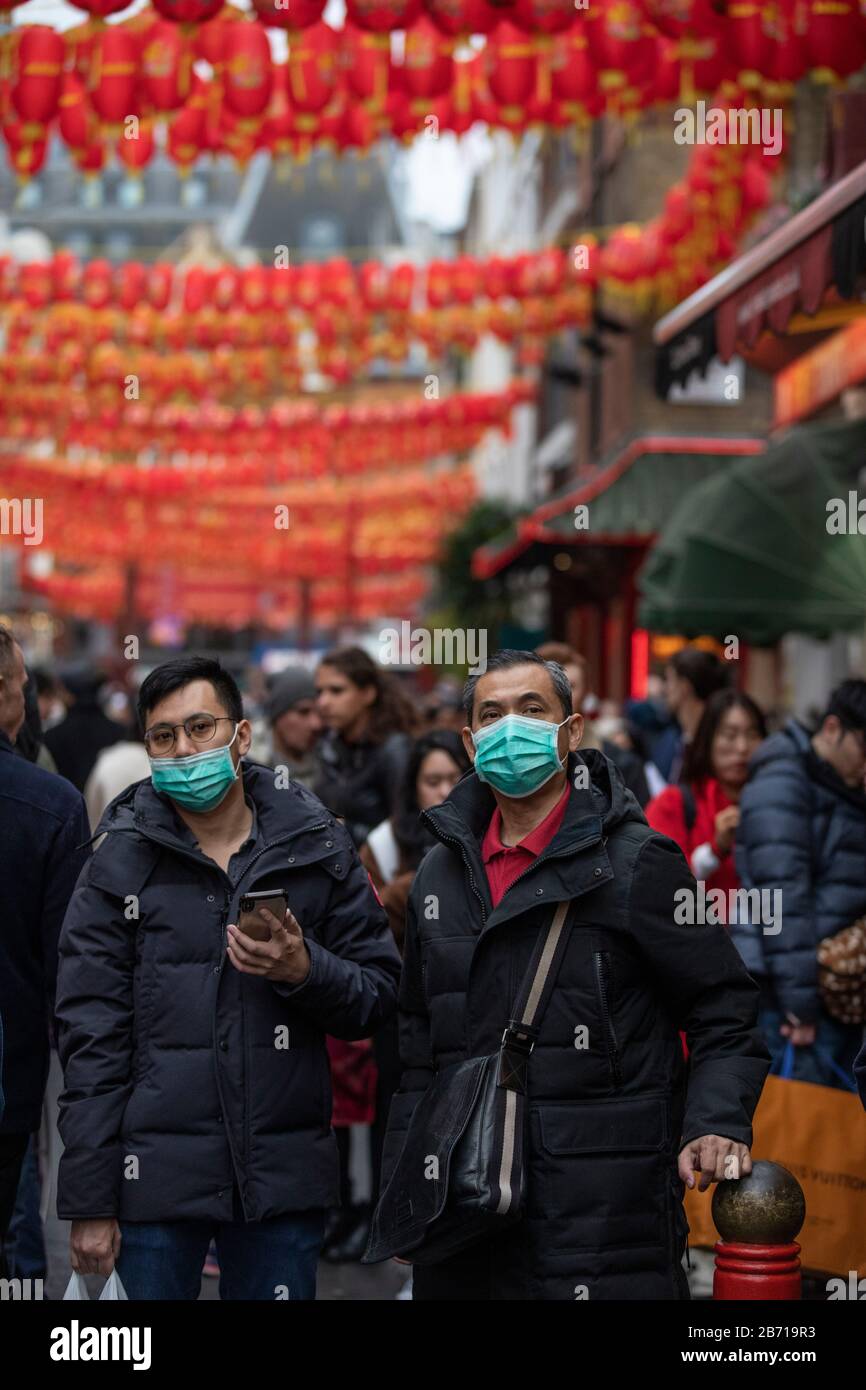 People wearing masks as precaution of catching Coronavirus at the Chinese New Year Celebration in London, Year of the Rat, Sunday 26th January 2020 UK Stock Photo