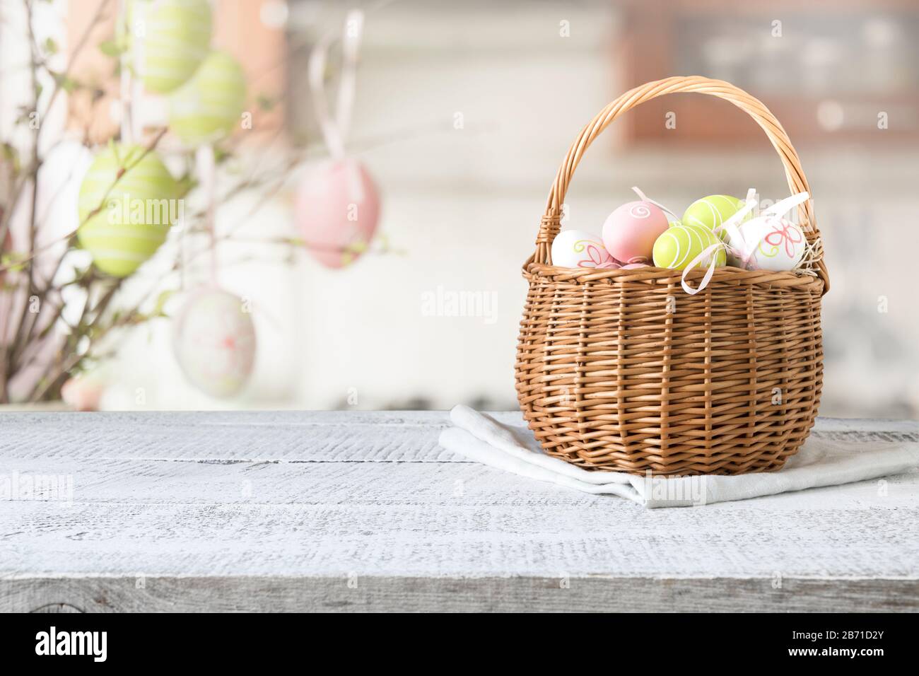 Basket with colorful pastel eggs on kitchen wooden tabletop. Spring easter  composition. Space for text or design Stock Photo - Alamy