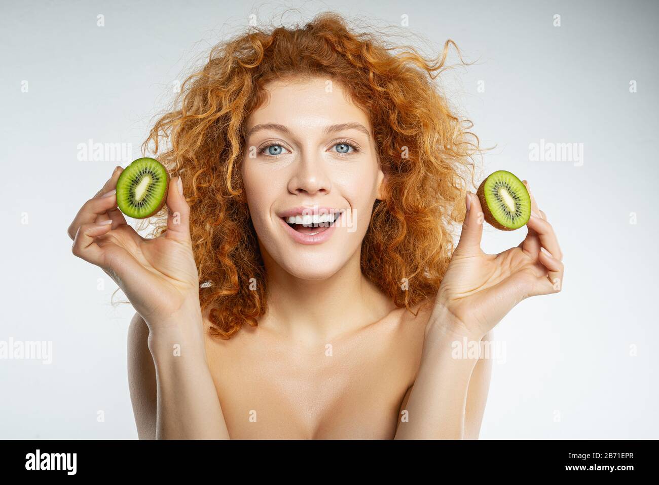 Close up of pretty girl that holding kiwi Stock Photo