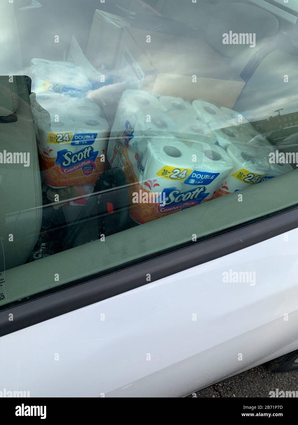 Dayton, OH- Mar 11, 2020: Back seat of car following fear buying of toilet paper due to corona virus scare. Ohio declaration of emergency. Stock Photo