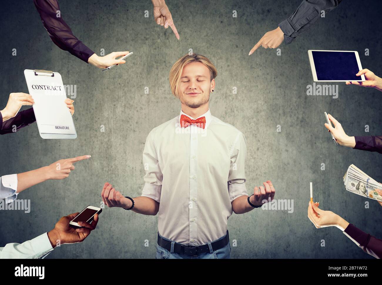 Young business man is meditating to relieve stress of busy corporate life Stock Photo