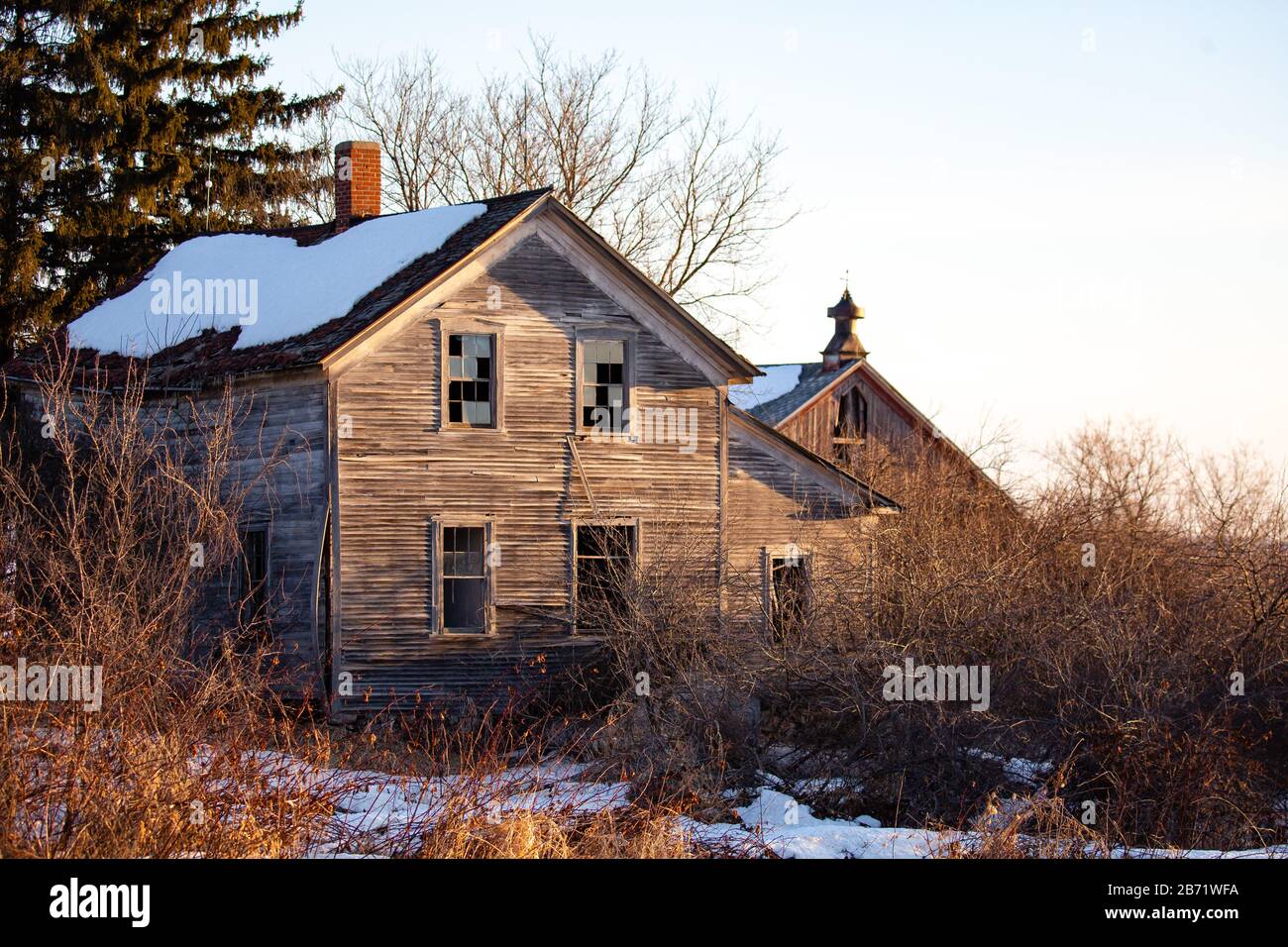 Old abandoned house and barn in Wisconsin during the winter Stock Photo