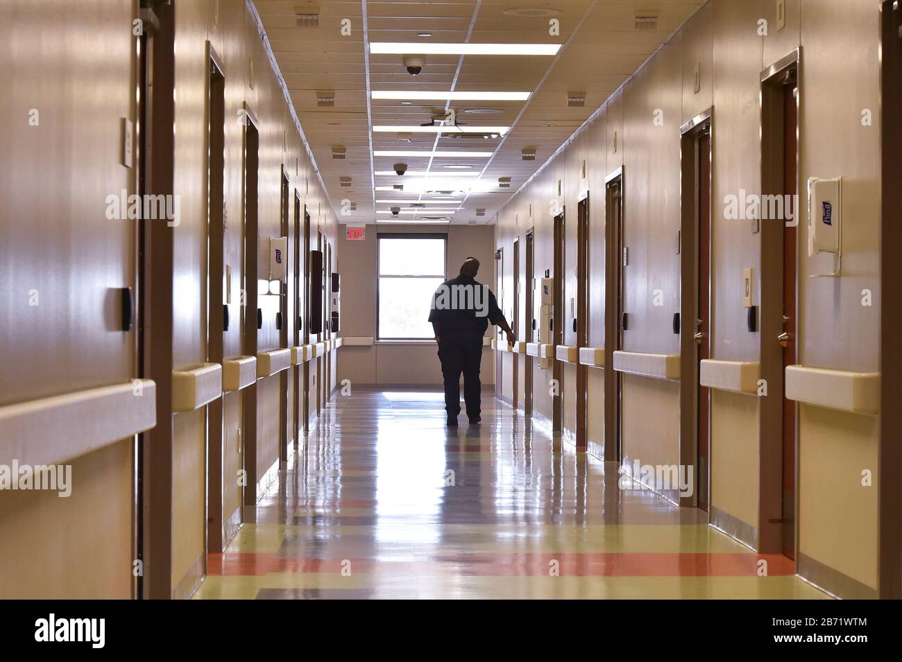 A security guard walks in the hallway of the Texas Center for Infectious Disease in San Antonio in this December 2018 file picture. Those who test positive for the coronavirus Covid 19 are being treated currently at the facility. Stock Photo