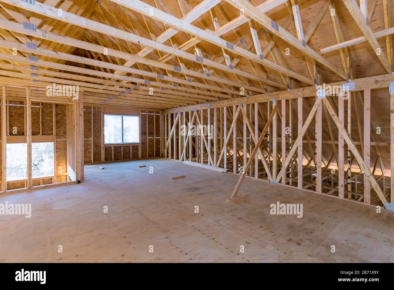 Interior of attic room with under reconstruction installing wooden frame for improvement a ...