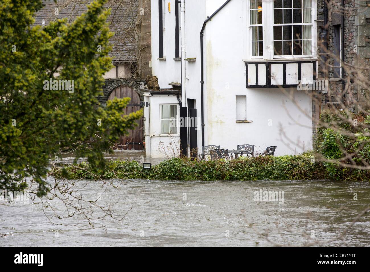 Flooding caused by Storm Ciara at Rothay Bridge in Ambleside, Lake District, UK, with an flooded house. Stock Photo
