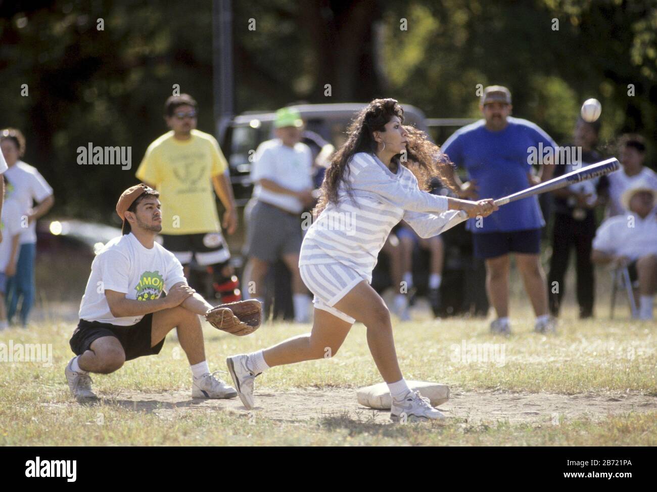 Austin, Texas USA Young Hispanic woman bats during Limon family