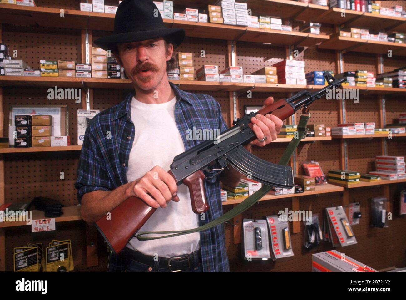 Austin, Texas: Man shopping for gun checks out merchandise in specialty store Just Guns. MR ©Bob Daemmrich Stock Photo