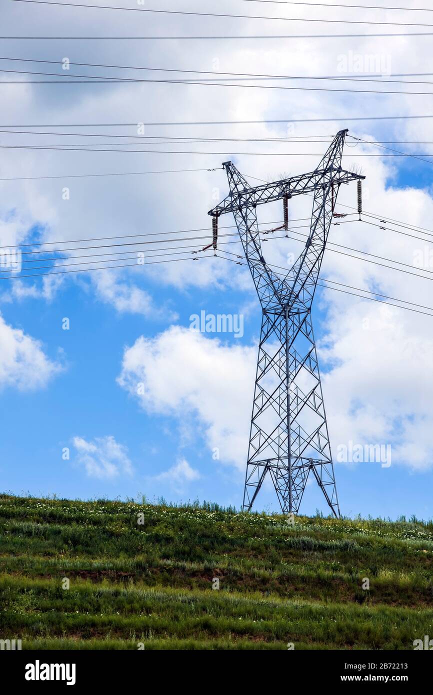 High voltage towers, under the blue sky white clouds Stock Photo - Alamy