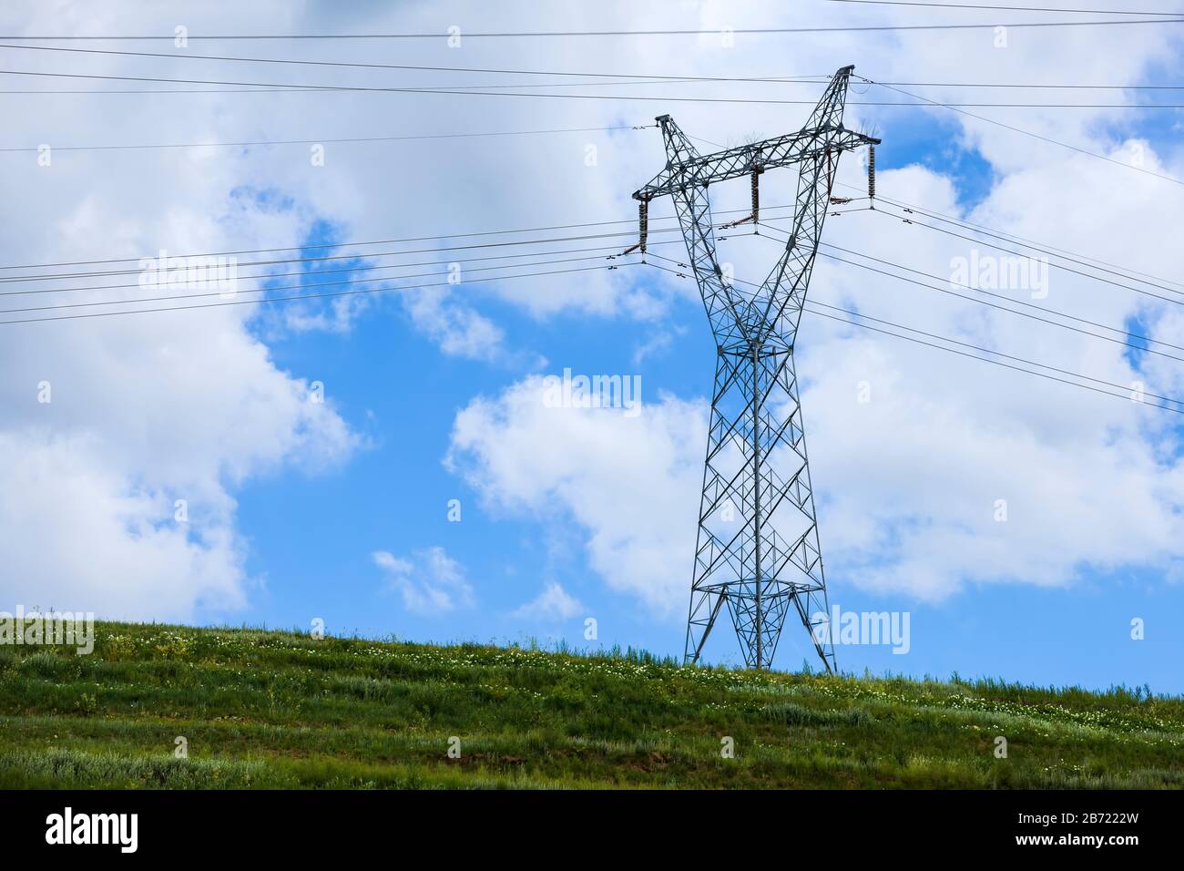 High voltage towers, under the blue sky white clouds Stock Photo - Alamy