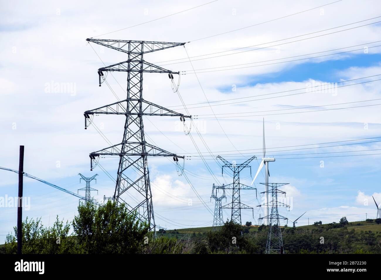 High voltage towers, under the blue sky white clouds Stock Photo - Alamy