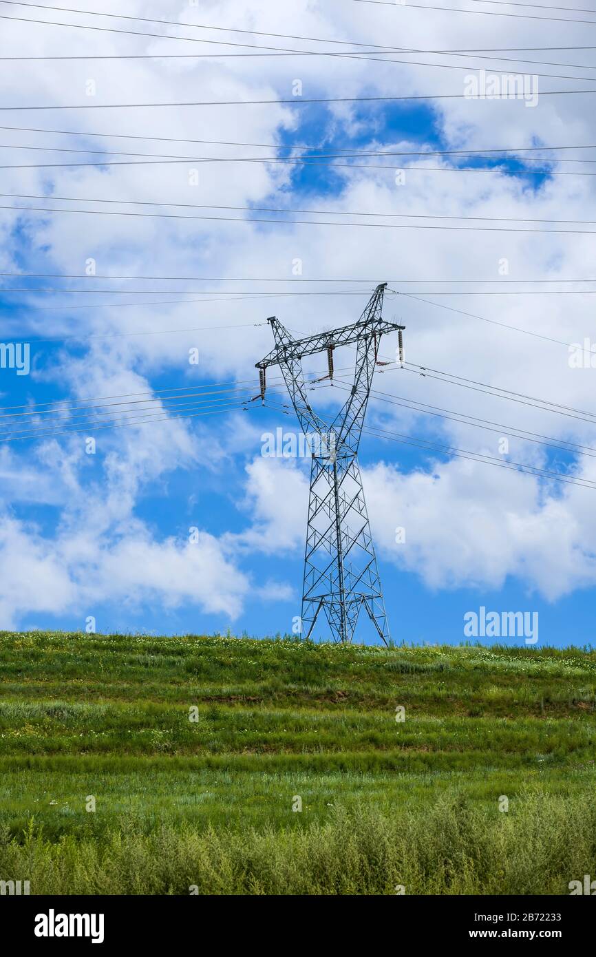 High voltage towers, under the blue sky white clouds Stock Photo - Alamy