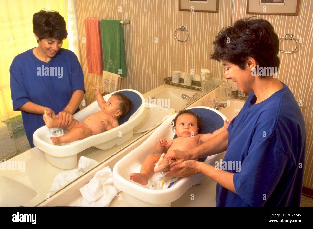 Austin, Texas USA, 1994 Mother bathes threemonthold baby boy in tub