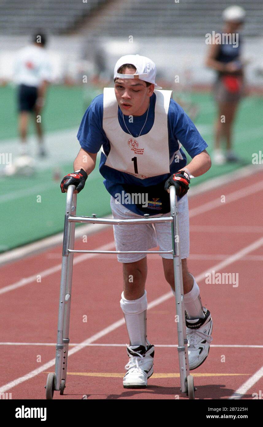 Austin, Texas USA:  Handicapped boy using walker competes in sprint event a Texas Special Olympics track meet. ©Bob Daemmrich Stock Photo