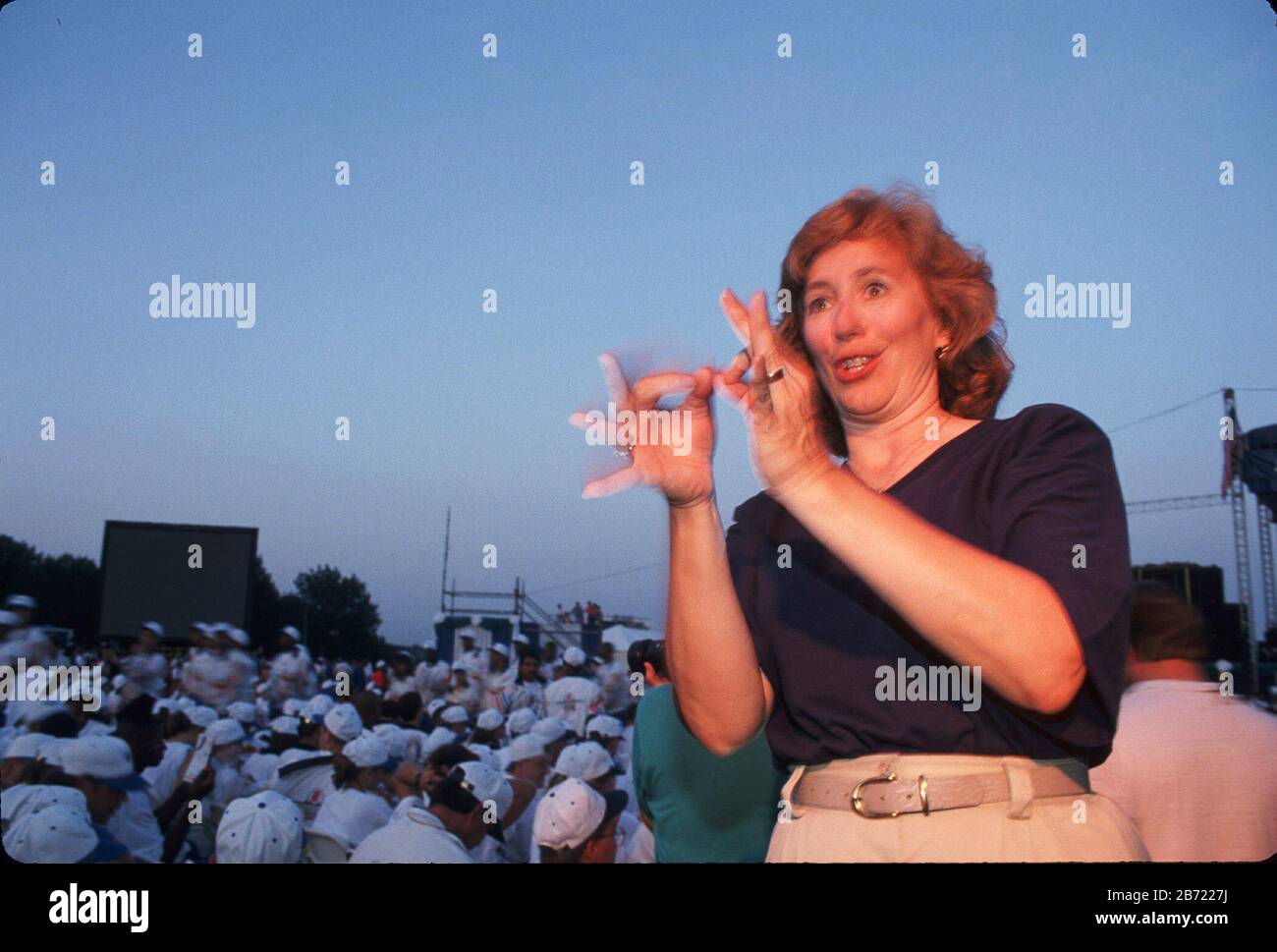 Austin Texas USA: Sign language interpreter at Fourth of July festivities, with crowd in background. ©Bob Daemmrich Stock Photo