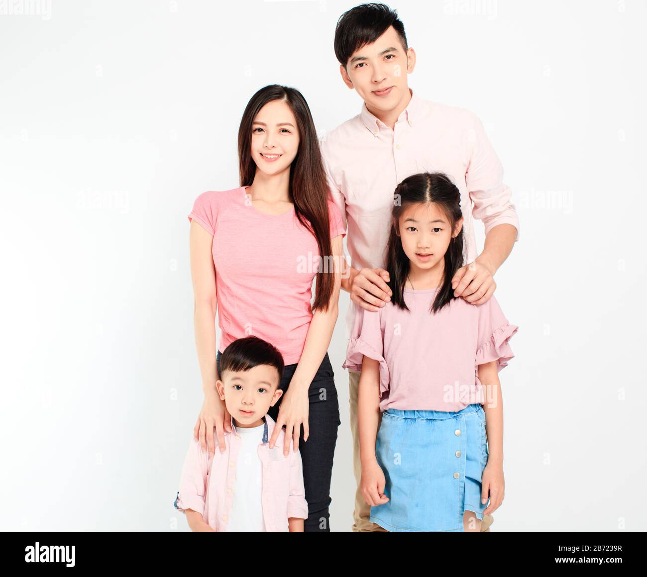 happy young asian family standing before white background Stock Photo