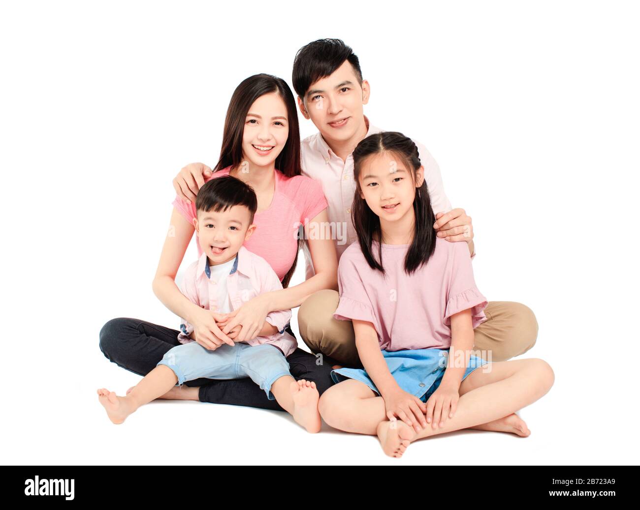 happy young asian family sitting on floor Stock Photo