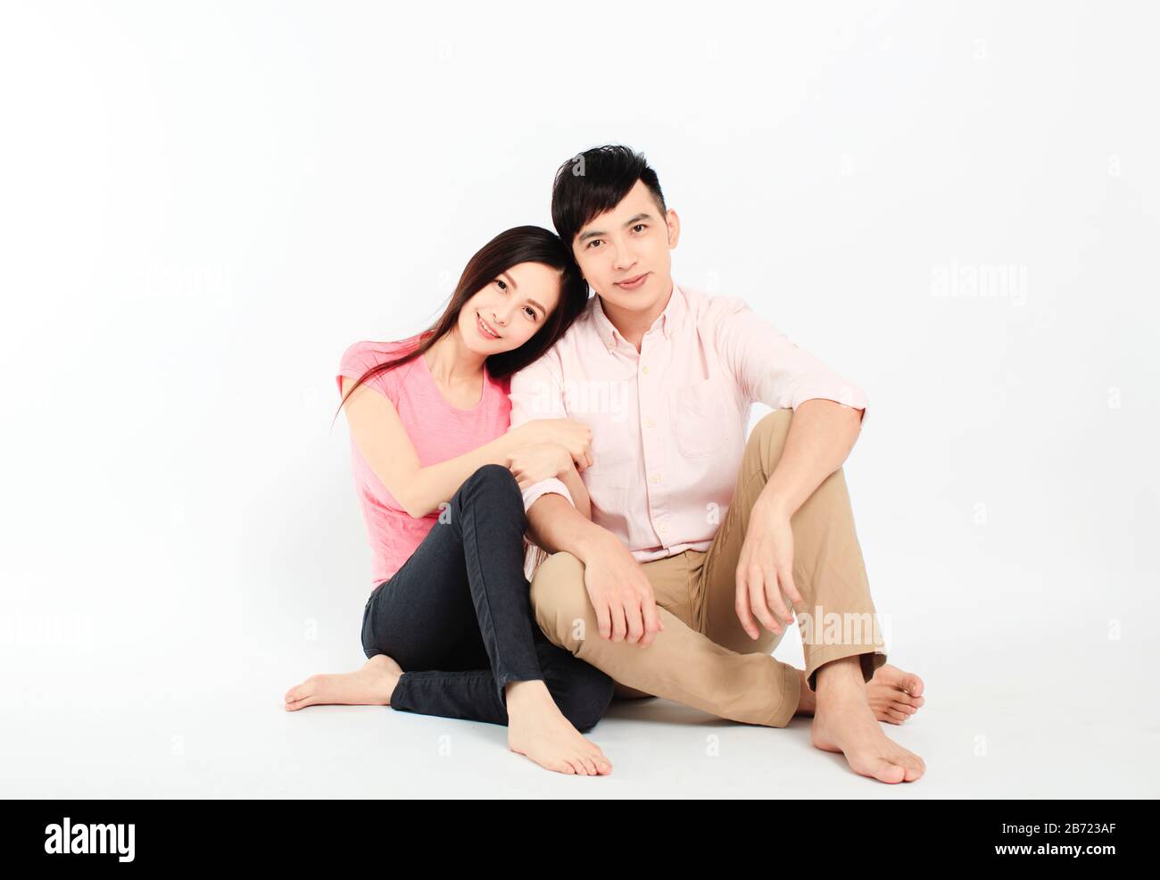asian young couple sitting on floor isolated on white background Stock ...