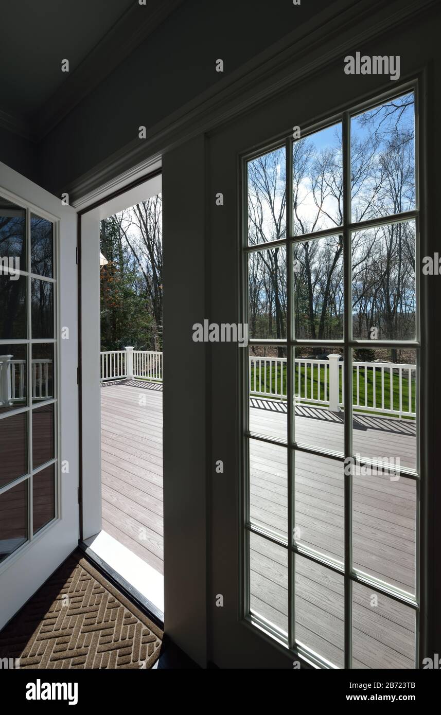 Garden deck view through the window glass. French door opening to  backyard. Stock Photo