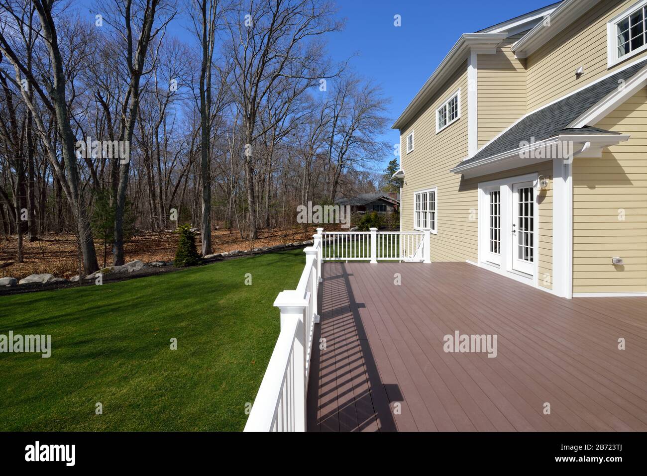 Large composite deck on colonial style house. Stock Photo