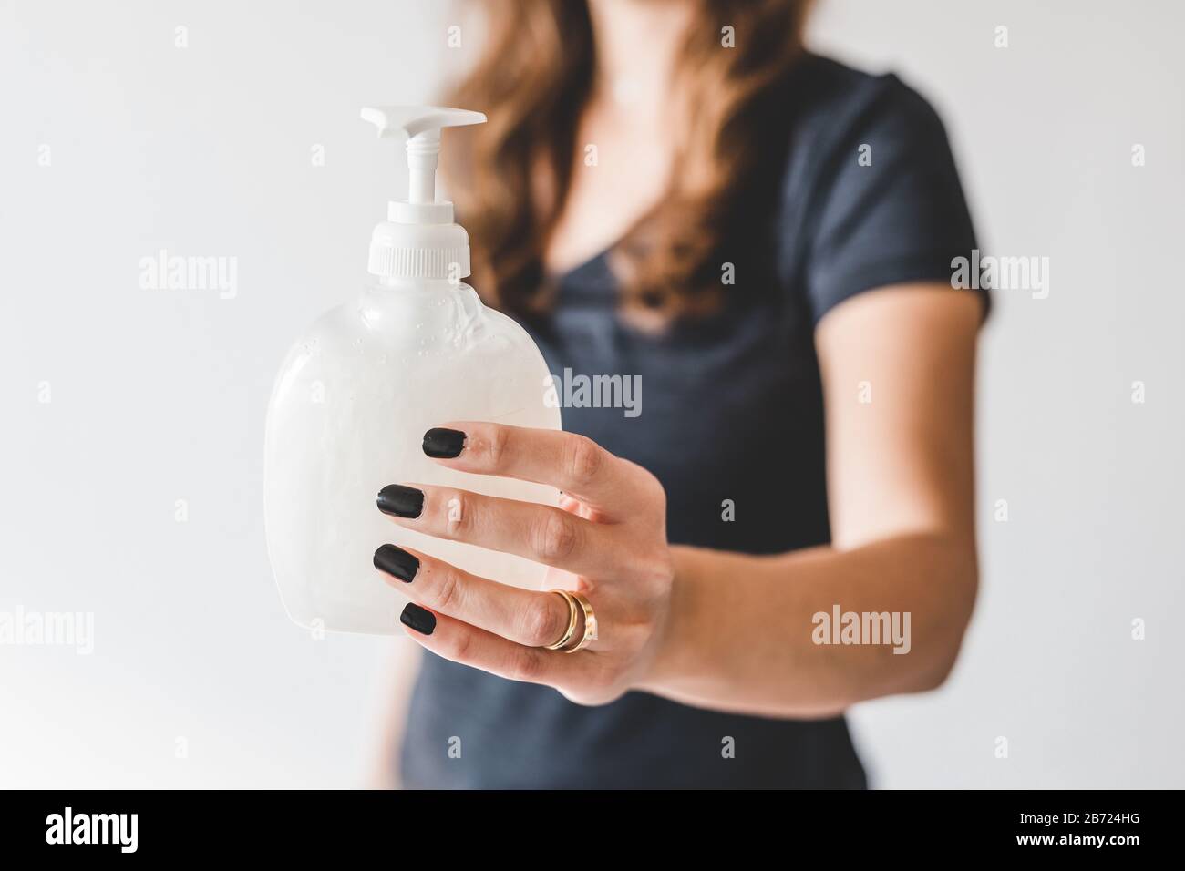 washing your hands against viruses and bacteria, woman holding bottle