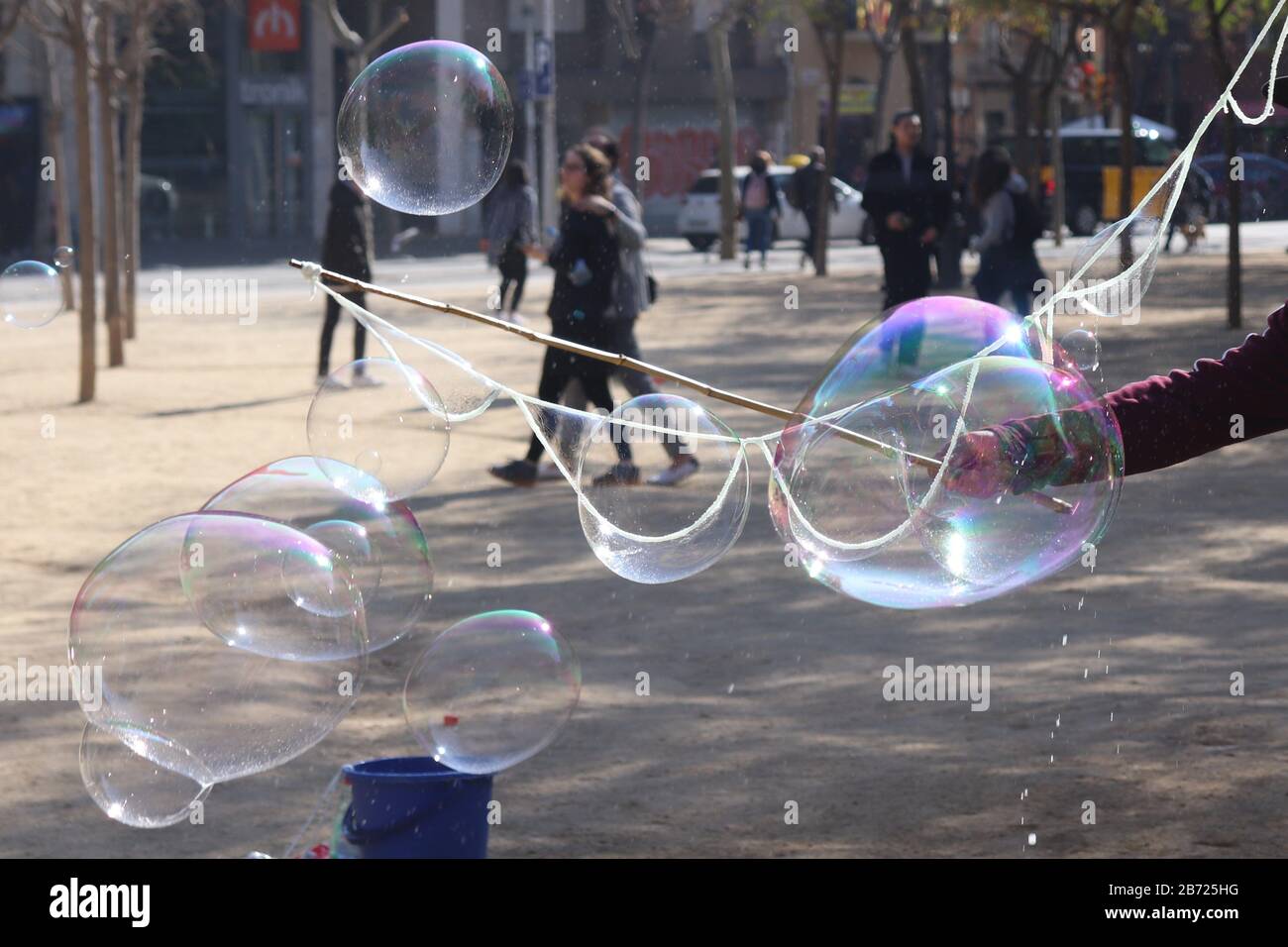 Bubbles in a park by a man, a lot of bubbles of different sizes Stock Photo