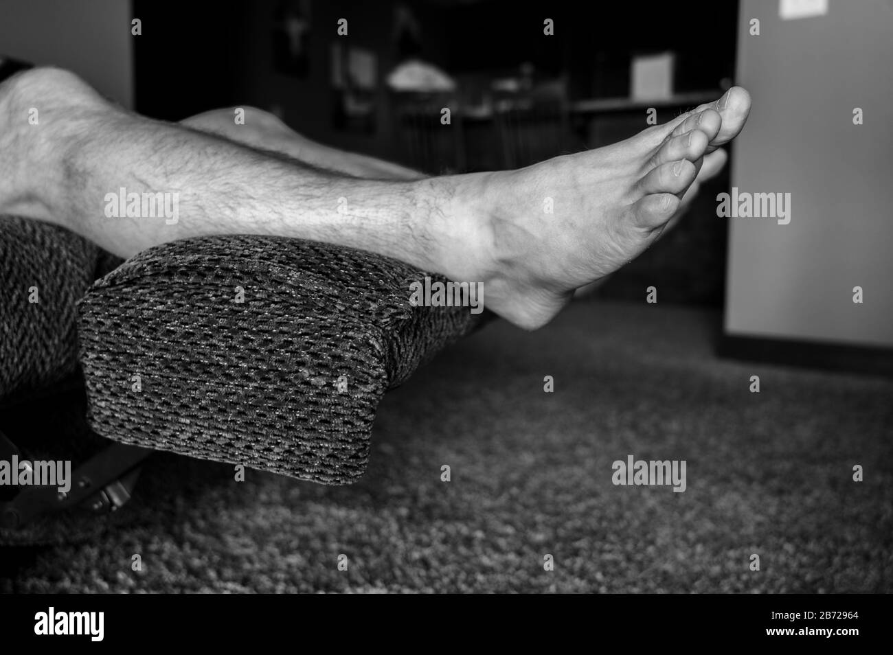 white Caucasian male with feet elevated on reclining chair Stock Photo Alamy