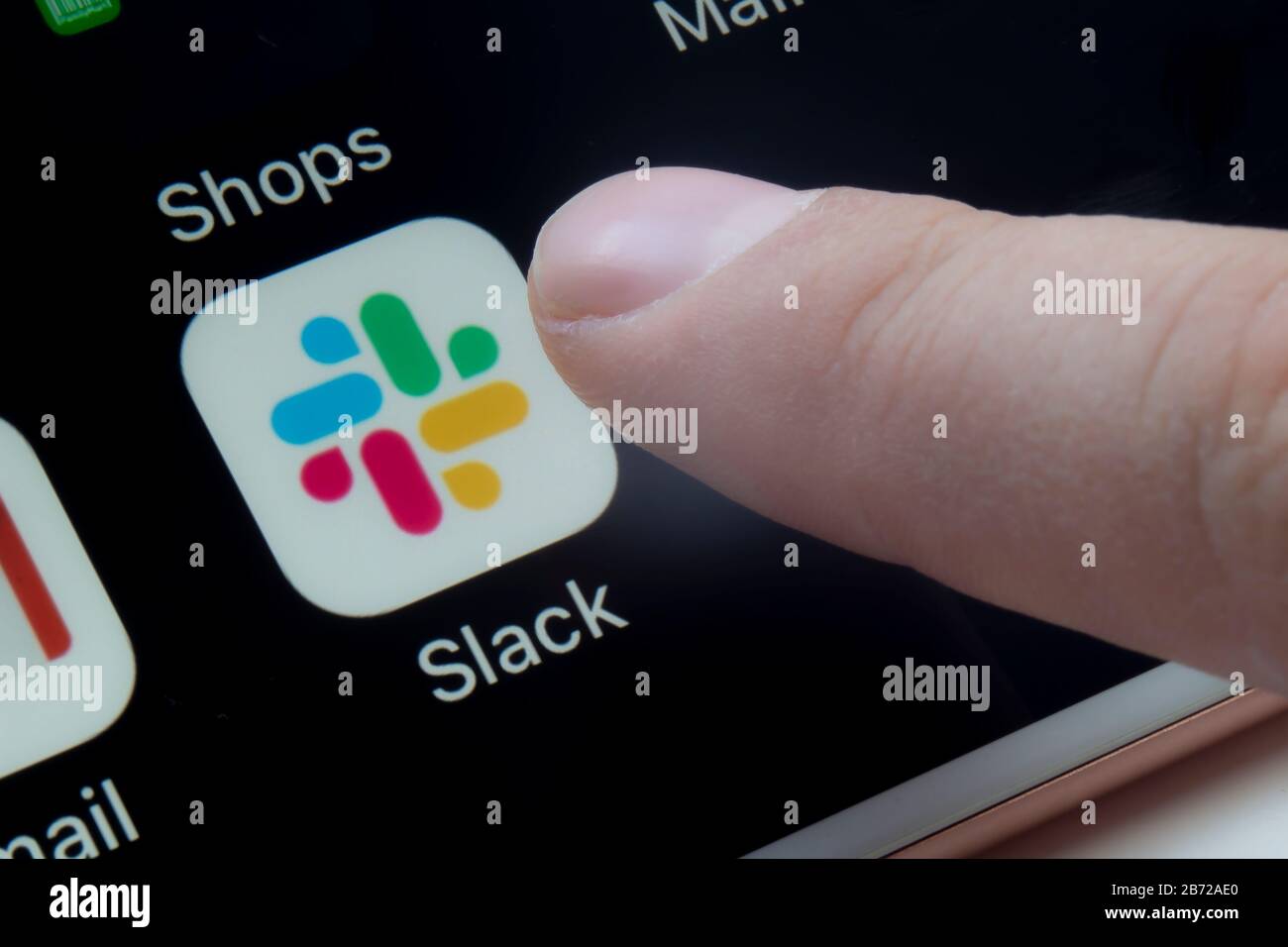 Calgary, Alberta, Canada. March 12, 2020.A person about to use Slack app which is a proprietary instant messaging platform Stock Photo